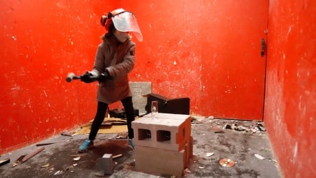 Grace Roswell, 12, celebrates her birthday by breaking things in the Vengeance Van, a rage room on wheels, in Ottawa on Tuesday, February 9, 2021. THE CANADIAN PRESS/Patrick Doyle Vengeance Van 20210307