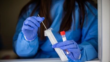 Health-care workers provide COVID-19 swabs at their drive-thru clinic in Central Park in Burnaby, British Columbia on Friday, March 26, 2021. BURNABY 1 year Anniversary covid testing site