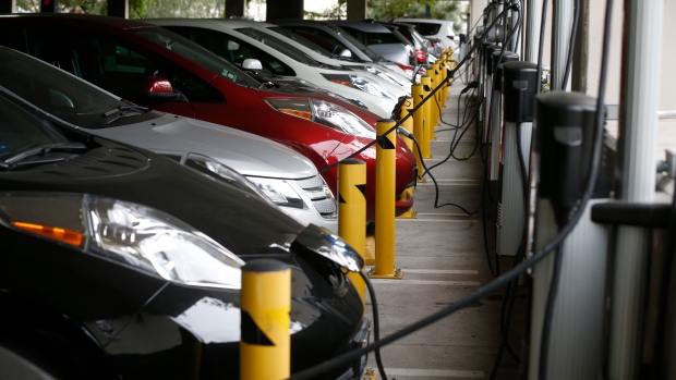 EV sales are still growing. So why are carmakers pulling back?; Electric cars sit charging in a parking garage at the University of California, Irvine January 26, 2015\.