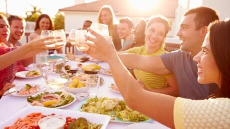 Group Of Young People Enjoying Outdoor Summer Meal; Shutterstock ID 205290715; Cost Ctr: 9688225; Manager: Brenda Carroll; Email: brenda.carroll@cbc.ca; Project: archive Shutterstock - medium file Summer Outdoor Meal