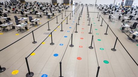 Calgary's Telus Convention Centre is now offering two free transit tickets for anyone who takes the bus or CTrain to their COVID-19 vaccine appointment. Calgary Telus Convention Centre vaccine lineup distancing vaccination site