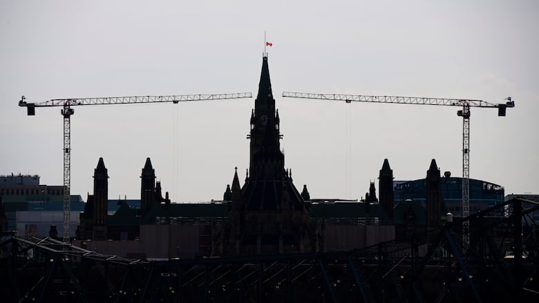 A tower crane framed by Parliament Hill.