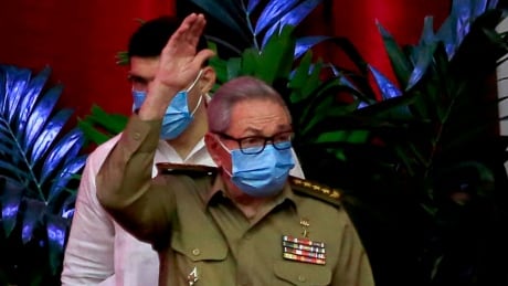 Raul Castro, first secretary of the Communist Party and former president, waves to members at the VIII Congress of the Communist Party of Cuba's opening session, as Cuban President Miguel Diaz-Canel, right, applauds at the Convention Palace, in Havana, Cuba, Friday, April 16, 2021. (Ariel Ley Royero/ACN via AP) Cuba Communist Party