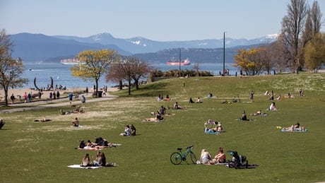 People are pictured in the sun on Sunset Beach in Vancouver, B.C., on Friday, April 16, 2021. Warm, sunny weather drove many in Metro Vancouver to the outdoors. People are pictured in the sun on Sunset Beach in Vancouver, B.C., on Friday, April 16, 2021. (Ben Nelms/CBC)