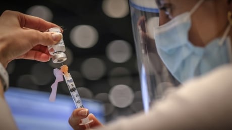 The AstraZeneca/Covishield vaccine is drawn at the Telus Convention Centre immunization site in Calgary on April 20, 2021. AstraZeneca vaccine shot nurse