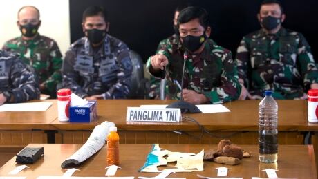 Indonesian Military chief Hadi Tjahjanto, centre, talks to media as they display debris found in the waters during a search operation for the Indonesian Navy submarine KRI Nanggala at Ngurah Rai Military Air Base in Bali, Indonesia on Saturday, April 24, 2021. Indonesia’s navy on Saturday said items were found from a missing submarine, indicating the vessel with 53 crew members had sank and there was no hope of finding survivors. Indonesian Military chief Hadi Tjahjanto speaks to media