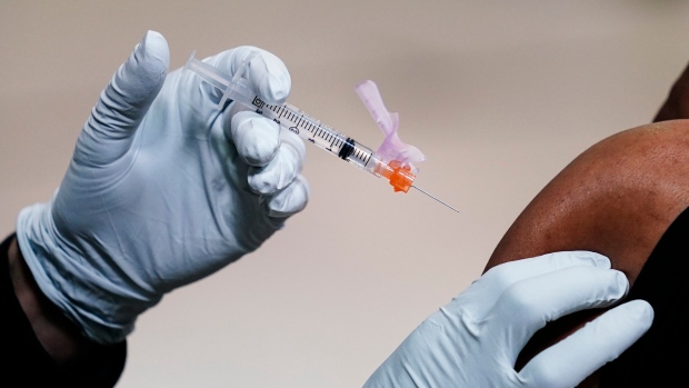 Canada approved multiple RSV shots to ward off infections this fall — here's how to get them; A member of the Philadelphia Fire Department administers the Johnson & Johnson COVID-19 vaccine to a person at a vaccination site setup at a Salvation Army location in Philadelphia, Friday, March 26, 2021\.