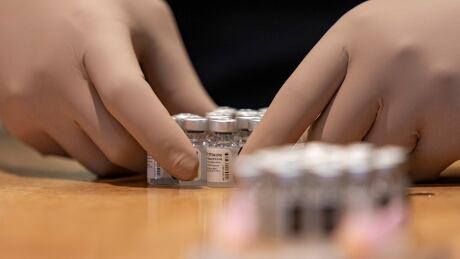Pharmacy technician Heron Roach prepares doses of the Pfizer-BioNTech COVID-19 vaccine at a temporary clinic at the Woodbine racetrack and casino, in northeast Toronto, on May 5, 2021. COVID-19 WOODBINE MASS VACCINE