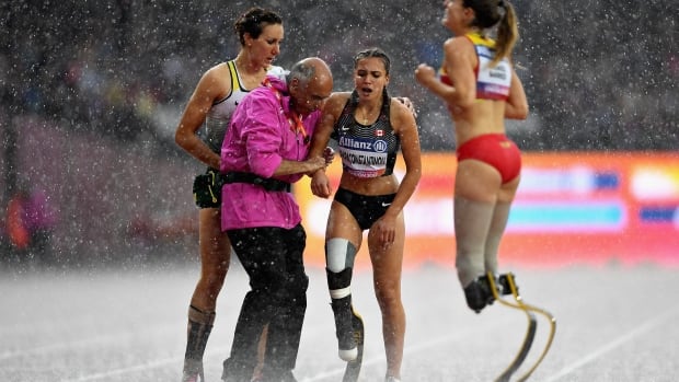 LONDON, ENGLAND - JULY 23: Marissa Papaconstantinou of Canada is helped from the track by Irmgard Bensusan of Germany after competing in the Womens 200m T44 final during day ten of the IPC World ParaAthletics Championships 2017 at London Stadium on July 23, 2017 in London, England. (Photo by Mike Hewitt/Getty Images) 821276646