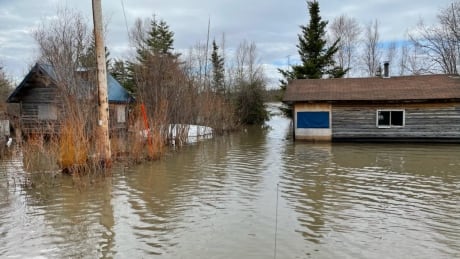 Homes in Little Buffalo River near Fort Resolution, N.W.T., seen on Thursday, May 13, 2021, engulfed in water. Little Buffalo River flood