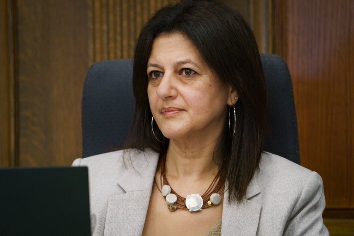 A woman sitting behind a desk