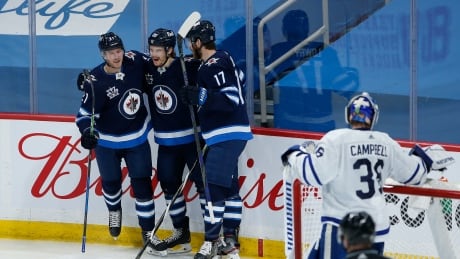 Winnipeg's Dominic Toninato, left, Mason Appleton, centre, and Adam Lowry, right, celebrate Appleton's second-period goal during the Jets' 4-2 victory over the Toronto Maple Leafs on Friday. appleton-mason-051421