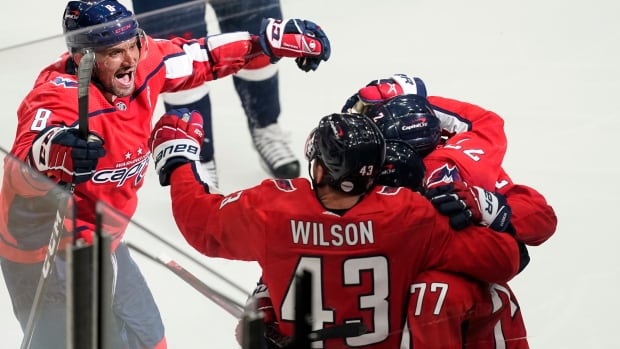 Washington Capitals' Alex Ovechkin (8) comes in to celebrate with teammates Tom Wilson (43), T.J. Oshie (77) and Justin Schultz (2) after Nic Dowd's game-winning goal during overtime against the Boston Bruins in Game 1 on Saturday night. Bruins Capitals Hockey
