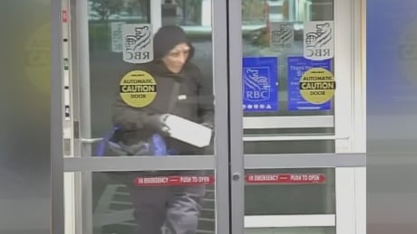 Justin Byron is captured on surveillance video wearing a disguise to plant an IED at an Edmonton bank in September 2018. RBC attempted robbery
