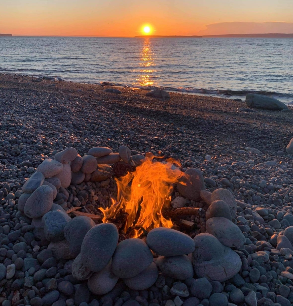 Fire on rocky beach