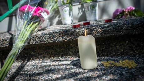 A man prays outside of the Al Masjid Al Jamia mosque near flowers in support of the recent hate crime in London while in Vancouver, British Columbia on Tuesday June 8, 2021. MUSLIM FAMILY ATTACK MEMORIAL