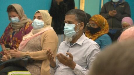 A man prays at a vigil at the Islamic Association of Saskatoon to remember four people who were killed in an attack motivated by anti-Muslim hate. saskatoon muslim vigil