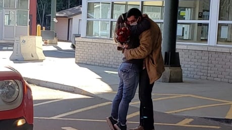 Sara Anderson and Joe Forgues embrace after seeing each other for the first time in 256 days at the Pigeon River border crossing, south of Thunder Bay, Ont. Sara Anderson and Joe Forgues