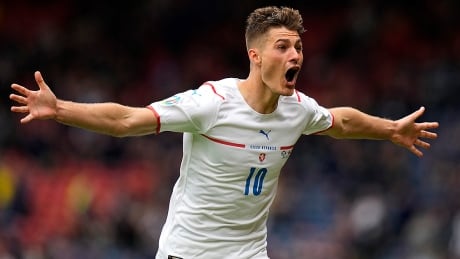 Patrik Schick of Czech Republic celebrates after scoring their side's second goal, a left-footed lob from 45 metres into an empty net, at Hampden Park in Glasgow on Monday. The win over Scotland moved the Czechs atop the Group D standings at Euro 2020. schick-patrik-210614-1180