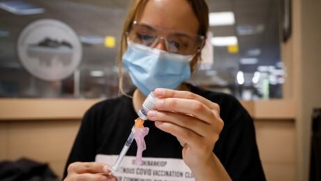 Nurse Iciar Bercian prepares a shot at a vaccine clinic for the homeless in Calgary on June 2. Scientists and doctors are warning that the more contagious delta variant could drive a fourth wave of cases, if not kept in check. COVID Homeless Vaccinations 20210603