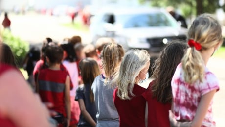 Students from Wolseley's elementary school stand near the funeral home. Wolseley elementary school students, June 15, 2021