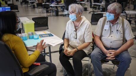 People getting vaccinations at the Telus Convention Centre in Calgary, Alta., in mid-April. ALBERTA VACCINES