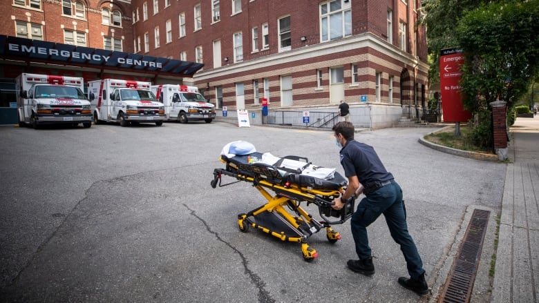 A B.C. Ambulance Service paramedic is pictured outside of St. Paul’s Hospital in Vancouver, British Columbia on Wednesday, June 30, 2021. 