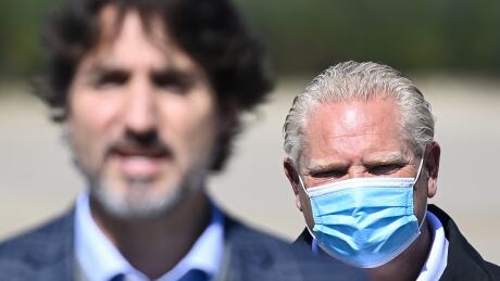 Canadian Prime Minister Justin Trudeau, front, speaks as Ontario Premier Doug Ford listens after taking part in a ground breaking event at the Iamgold Cote Gold mining site in Gogama, Ont., on Friday, September 11, 2020. Ont Trudeau Gold Mine 20200911
