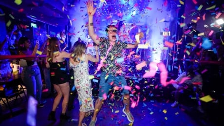 A man jumps on the dance floor shortly after the reopening, at The Piano Works in Farringdon, in London, Monday, July 19, 2021. The country's nightclubs are reopening for the first time in 17 months as almost all coronavirus rules are set to be scrapped. APTOPIX Virus Outbreak Britain