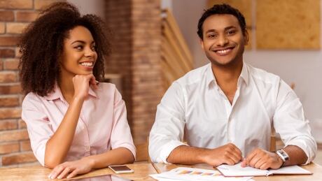 Young Black couple using tablet, making notes, looking in camera and smiling while working in cafe; Shutterstock ID 373339906 Shutterstock - Huge file