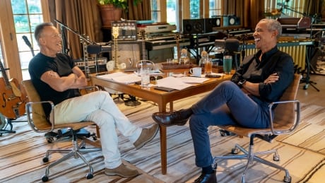 Bruce Springsteen, left, appears with former President Barack Obama during their podcast of conversations recorded at Springsteen's home studio in New Jersey. The eight-episode series covers their upbringings, racism, fatherhood and even recall a White House singalong around a piano. (Rob DeMartin/Spotify via AP) Spotify-Obama & Springsteen