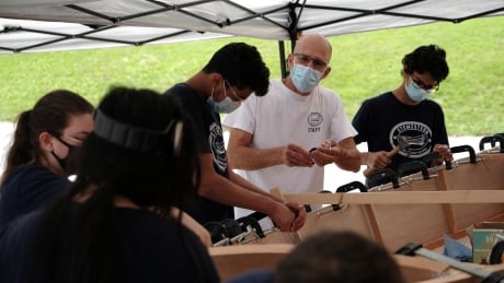 David Vine leading a group of eight youth outside of the Northwest London Resource Centre, in the parking lot, where they set up for the Stem2Stern boat-building workshop. Boat making workshop