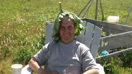 Life-long gardener Edward Griffin wears his prized 41-centimetre wide cabbage leaf as a hat. edward griffin lower north shore greenhouse volunteer
