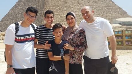Abdallah Alhamadni (right) is pictured with his wife and children after being reunited in Egypt. Abdallah Alhamadni
