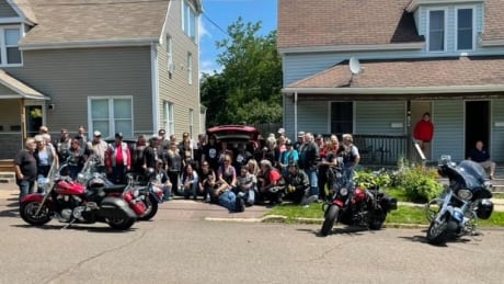 On Saturday morning, 52 bikers rode past Susan Voth's house to present her with money and flowers following her accident last week. Bike community with Susan Voth