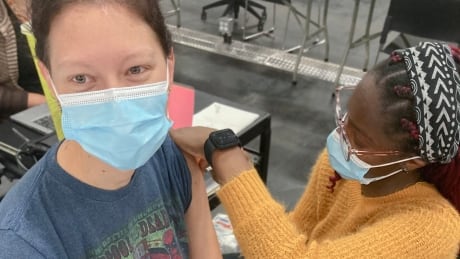 Ami Tymchak, 29, gets a COVID-19 vaccine shot on July 22. Alberta Health says 54.3 per cent of Albertans are now fully vaccinated against the virus, and 64.2 per cent have now received at least one dose. vaccine covid alberta