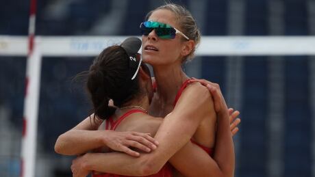 Canadian duo Melissa Humana-Paredes, left, and Sarah Pavan celebrate after earning a straight-sets (21-13, 24-22) victory over Switzerland's Joana Heidrich and Anouk Vergé-Dépré on Thursday in Tokyo. 1331195556