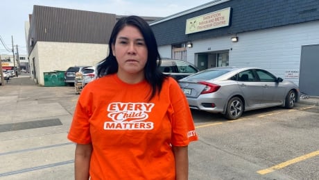 Melissa Parkyn, a worker with the Saskatoon Indian and Metis Friendship Centre, wears an Every Child Matters T-shirt on July 29, 2021. Melissa Parkyn