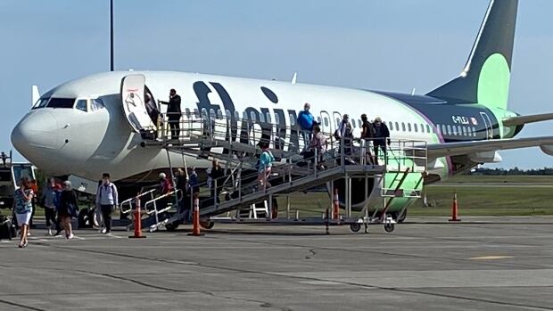 The first passengers get off a Flair Airlines flight at Charlottetown Airport. Flair will not be operating out of Charlottetown at all next year. people getting off airplane