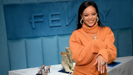 Rihanna poses in front of products from her Fenty fashion line, Feb. 7, 2020 in New York City. The 33-year-old is now a billionaire, Forbes magazine reported on Wednesday, but not because of her music. 1204749584