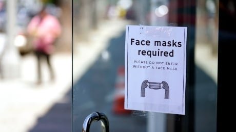 A sign advises shoppers to wear masks outside of a store Monday, July 19, 2021, in the Fairfax district of Los Angeles. Infections are climbing across the U.S. and mask mandates and other COVID-19 prevention measures are making a comeback in some places as health officials issue increasingly dire warnings about the highly contagious delta variant. But in a possible sign that the warnings are getting through to more Americans, vaccination rates are creeping up again, offering hope that the nation could yet break free of the coronavirus if people who have been reluctant to receive the shot are finally inoculated. Sign in L.A.'s Farifax district advises shoppers masks are required inside