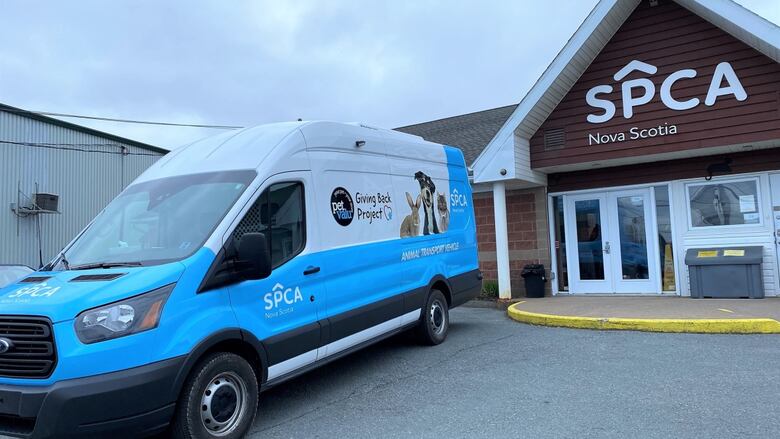 A blue and white van sits outside the SPCA shelter in Dartmouth