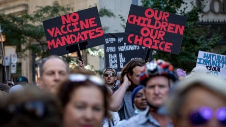 Hundreds of people gather in front of Toronto police headquarters for an anti-mandatory vaccination rally on Sept. 2, 2021 — a day after the Ontario government announced a vaccine passport system that will go into effect on Sept. 22. Anti-vaccine passport rally