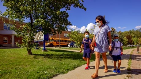 Afrooz Cianfrone is seen in Woodbridge, Ont., picking up her children Jobim and Dante from school after their first day on Wednesday, September 8, 2021. Afrooz Cianfrone