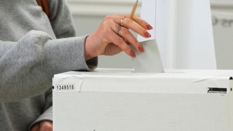 A voter casts their ballot in the advance polls, Friday, September 10, 2021 in Chambly, Que. Canadians will vote in a federal election Sept. 20th. THE CANADIAN PRESS/Ryan Remiorz FedElxn Advance Polls 20210910