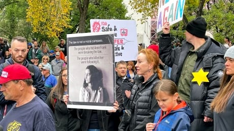 Protesters in Calgary held signs comparing the plight of Jewish victims of the Holocaust to workers who are being asked by their employers to get vaccinated for COVID-19 (and who can access medical or religious exemptions). Calgary vaccine protest anti-vaxx mandatory vaccination