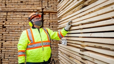 Darcy Elliott, shipping supervisor at Spray Lake Sawmills, inspects lumber at the facility in Cochrane, Alta., Thursday, May 20, 2021.THE CANADIAN PRESS/Jeff McIntosh lumber yard darcy elliott