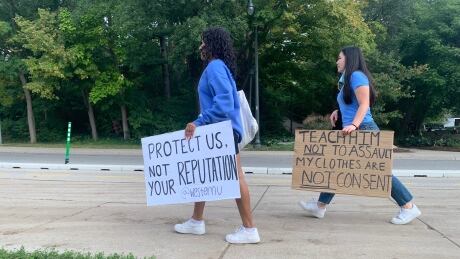 Western University students carry placards to protest sexual violence on campus, and the school's response to assaults that took place in early Sept. 2021. Western University students walkout