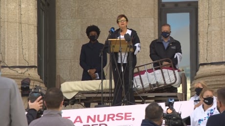 In front of an empty bed meant to signify the lack of staffing at the bedside, Manitoba Nurses Union president Darlene Jackson speaks on the front steps of the Manitoba Legislature to mark the Nurses' National Day of Action. Nurses’ National Day of Action