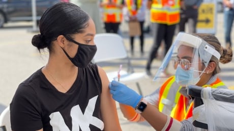 A person receives a COVID-19 vaccine dose through the Vax Van, a mobile vaccination clinic run by Peel Region, at Westwood Square Mall in Mississauga on Sept. 16, 2021. Peel Vax Van